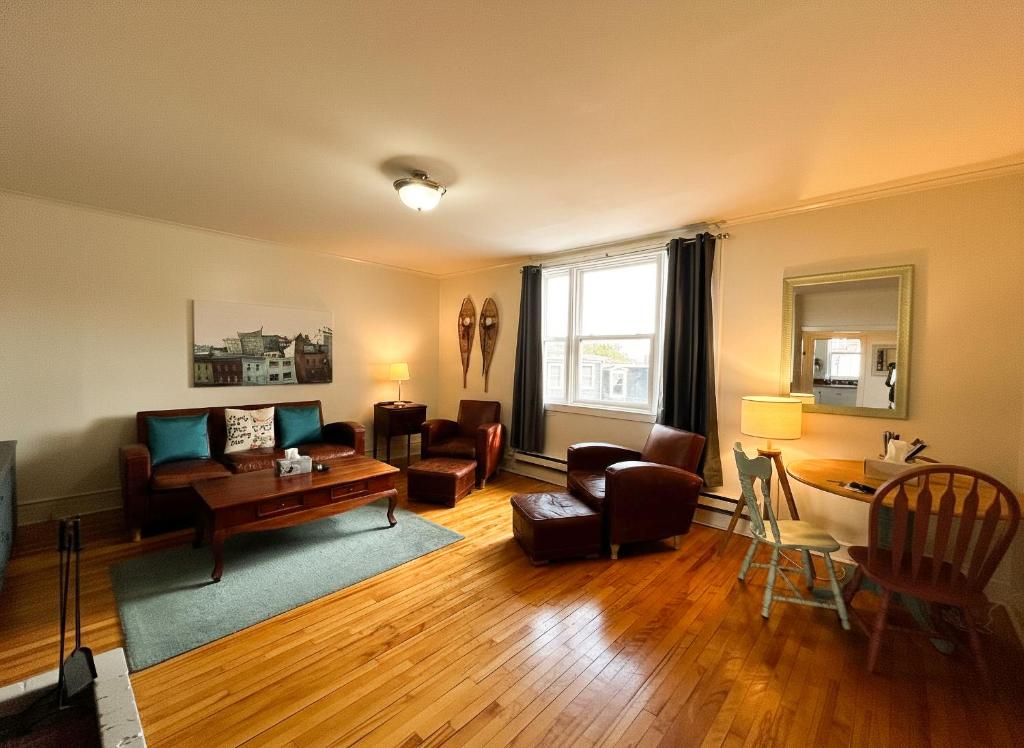 a living room with a couch and a table at Downtown Apt #6 Amazing View - 23 Queen's Rd in St. John's