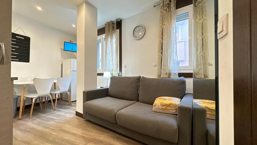 a living room with a couch and a dining room at Sky 401 by CONFORTSKY in Pas de la Casa