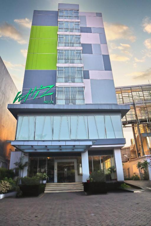 a building with a tall building with at Whiz Hotel Cikini Jakarta in Jakarta