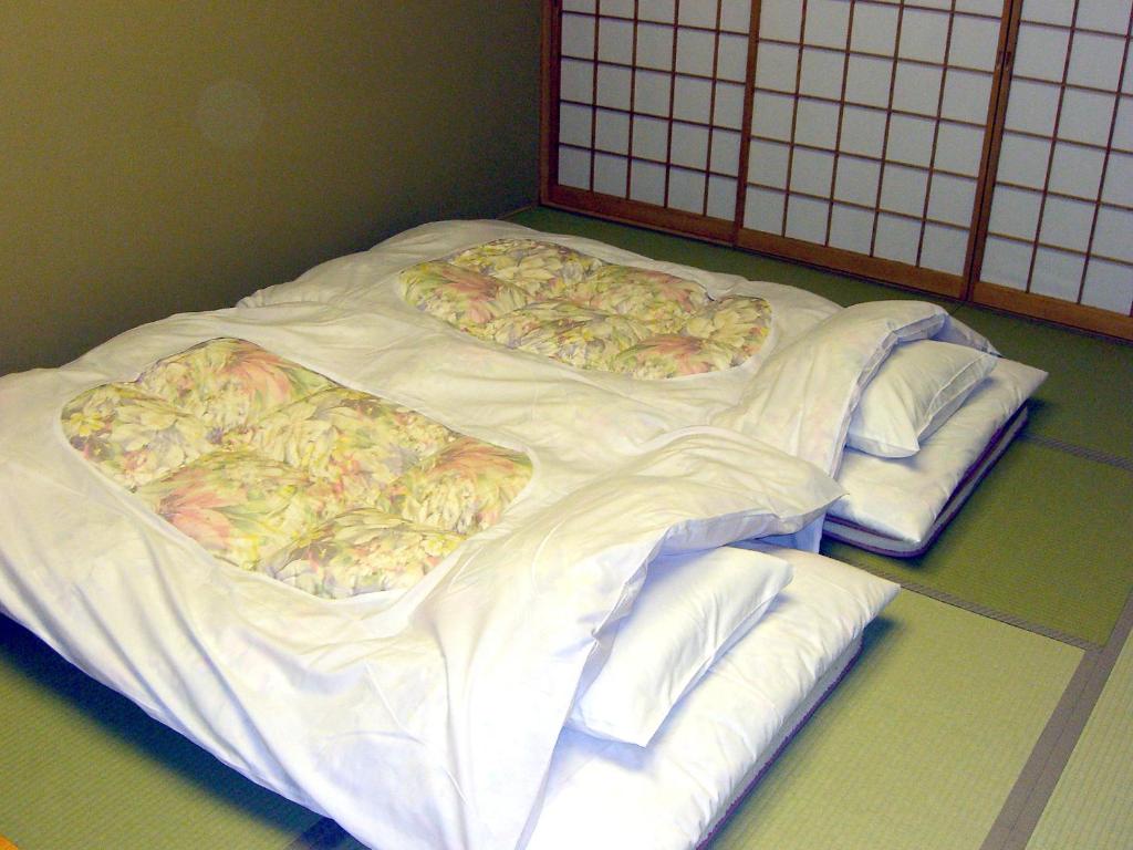 Postel nebo postele na pokoji v ubytování Nikko Senhime Monogatari