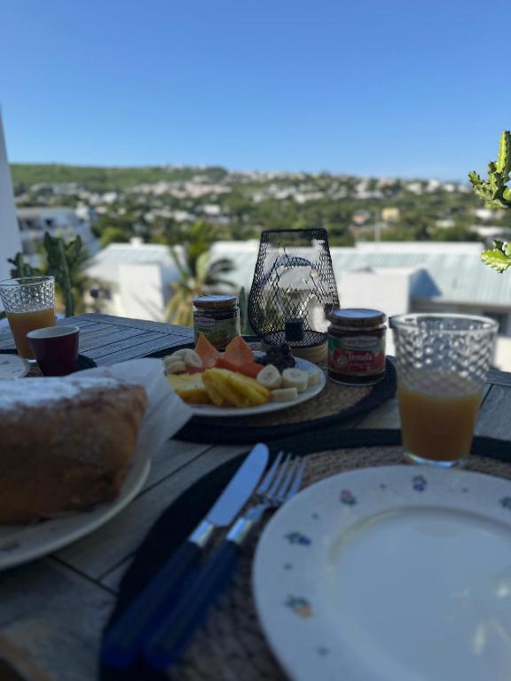 a table with plates of food and drinks on it at Ti Coin Soleil in Saint-Paul