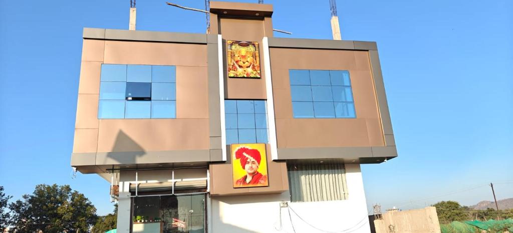 a building with two posters on the side of it at Ram Priya hotel in Basāri