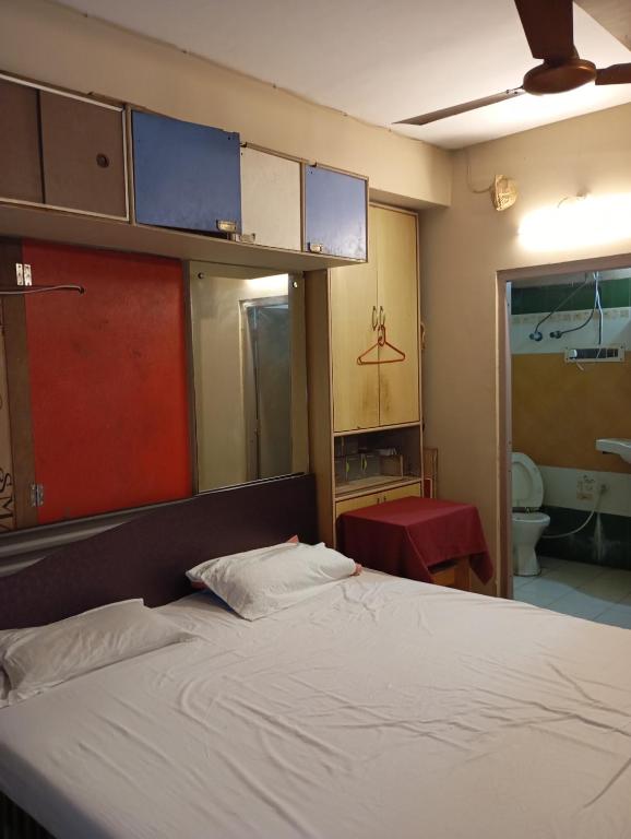 a bedroom with a bed and a bathroom at Stay on Ganges near Dakshineswar in Howrah