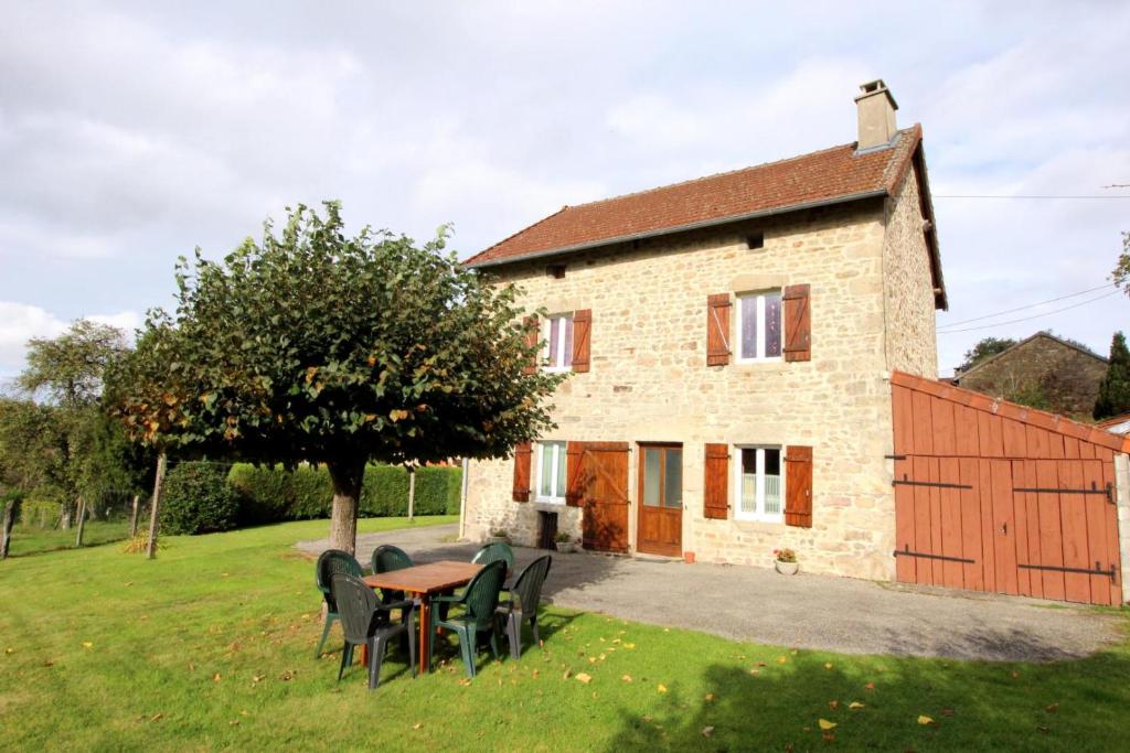 a house with a table and chairs in front of it at Négrignas in Augne