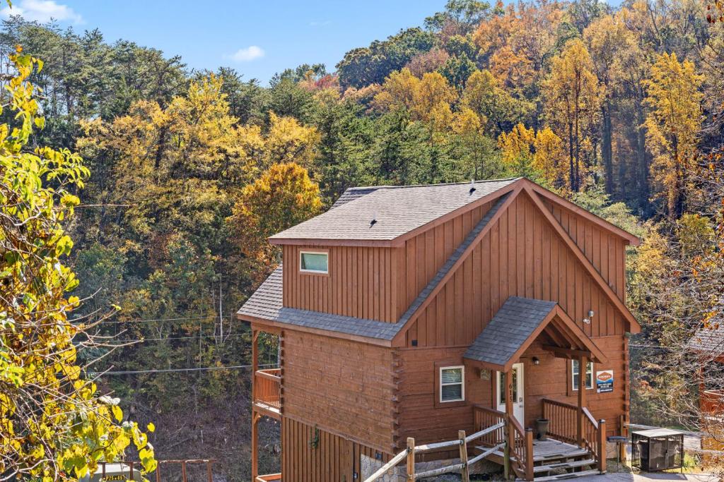 a house in the middle of a forest at Enchanted Forest Hideaway by Ghosal Luxury Lodging in Pigeon Forge