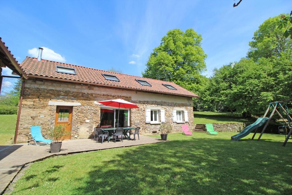 a house with a patio and a playground at Amboiras in La Croisille-sur-Briance