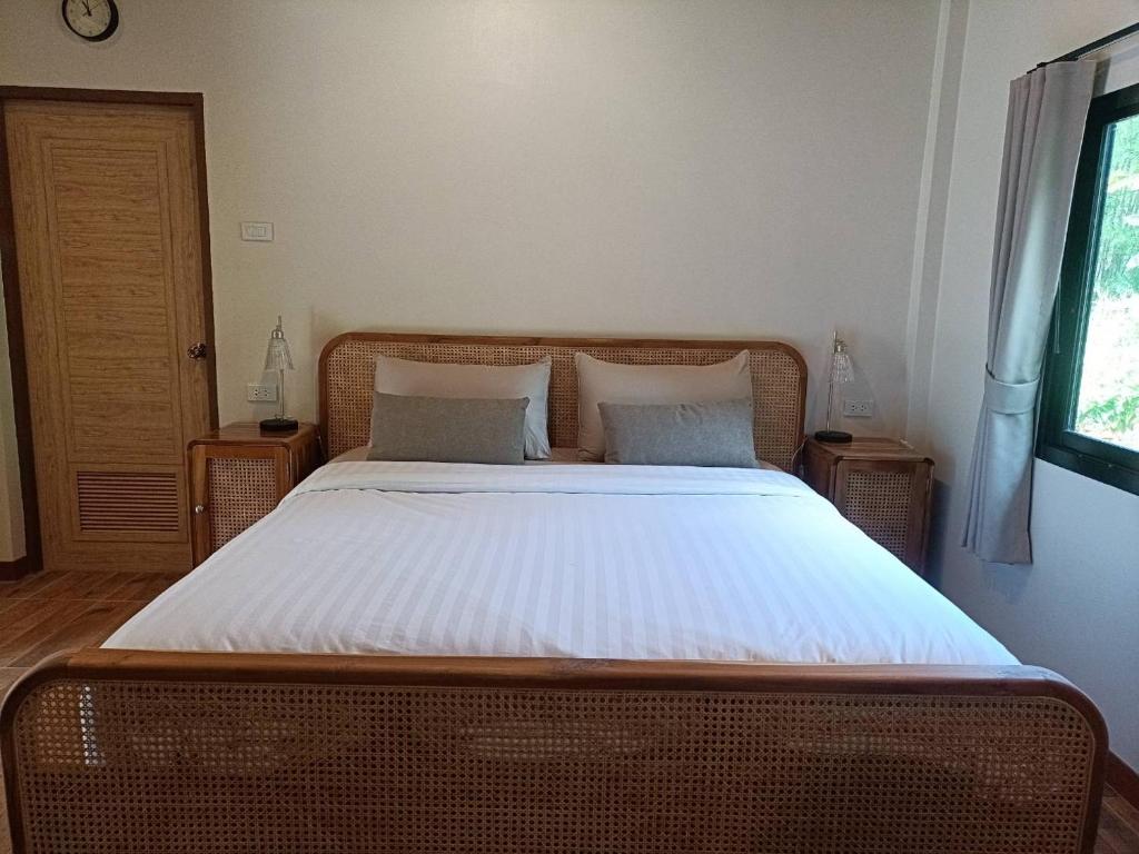 a bedroom with a large bed with white sheets at Than Khao Nature Resort and Homestay - Krabi Noi in Krabi