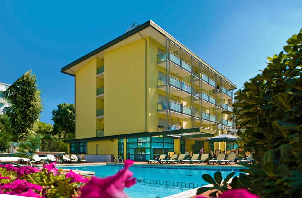 un hotel con piscina e un edificio di Hotel Concordia 3S a Bibione