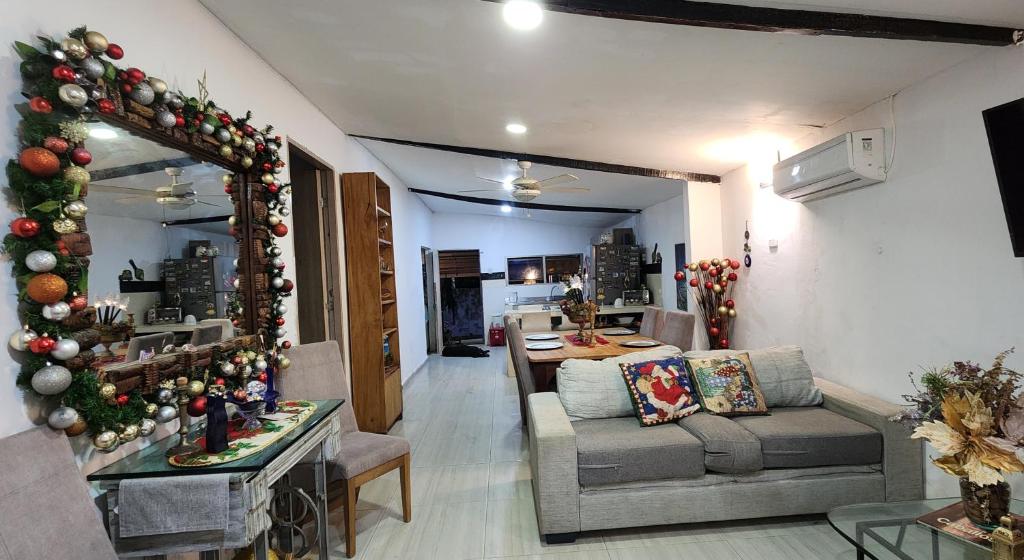 a living room with a christmas tree and a couch at Casa de Playa Salgar in Puerto Colombia