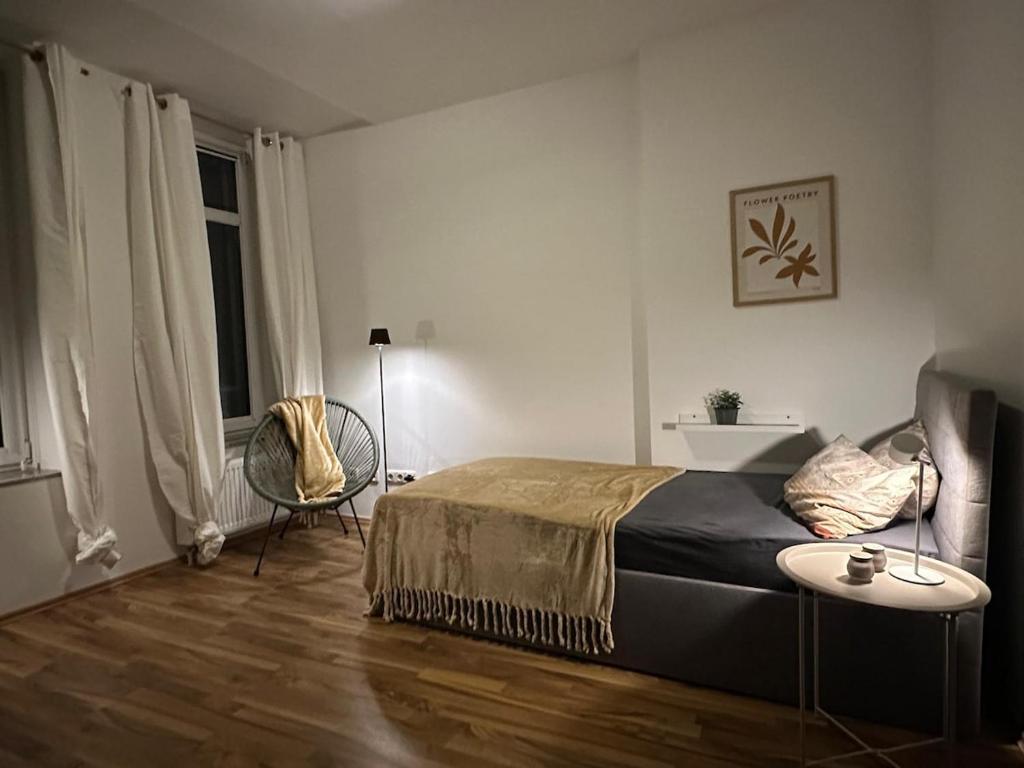 a bedroom with a bed and a table and a chair at Lee 42,8 in Bremerhaven