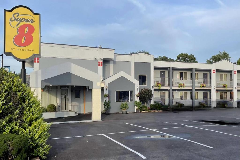 a hotel with a parking lot in front of it at Super 8 by Wyndham Belleville St. Louis Area in Belleville