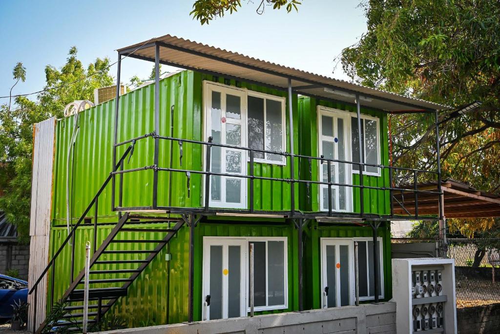 a green house with stairs on it at KH habitaciones in Manzanillo