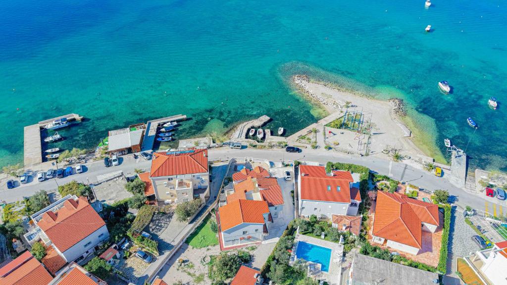 an aerial view of a beach with houses and the ocean at Luxury Beach Villa, Sibenik in Šibenik