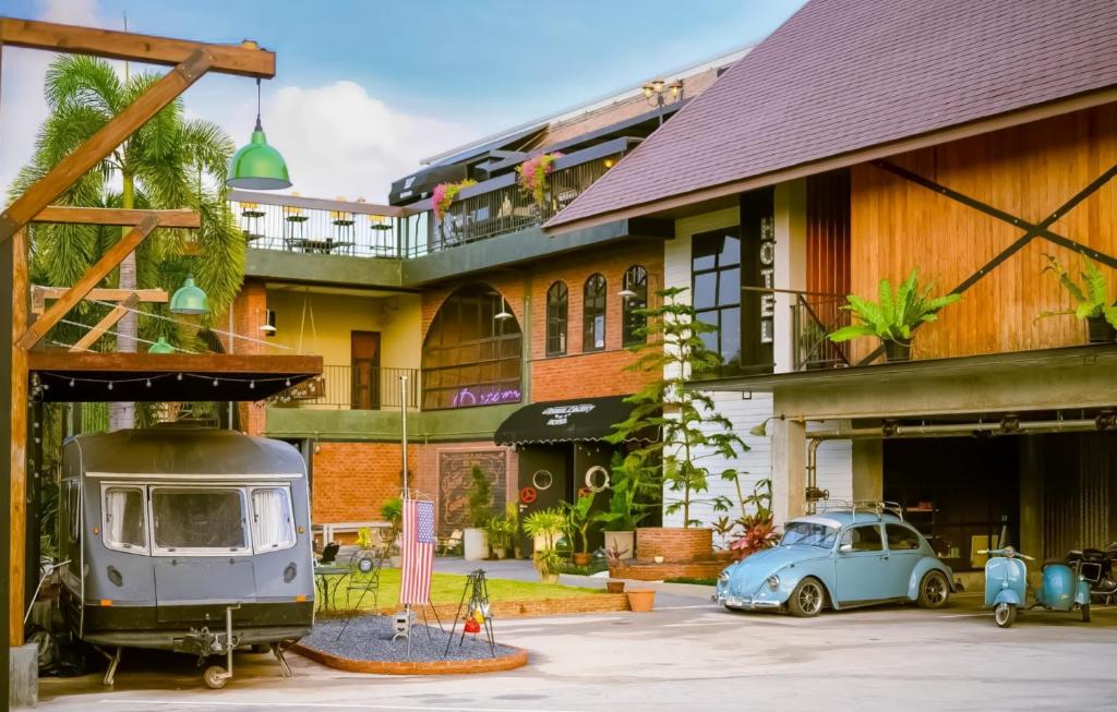 an old car parked in front of a building at Dream Factory Hotel in Udon Thani