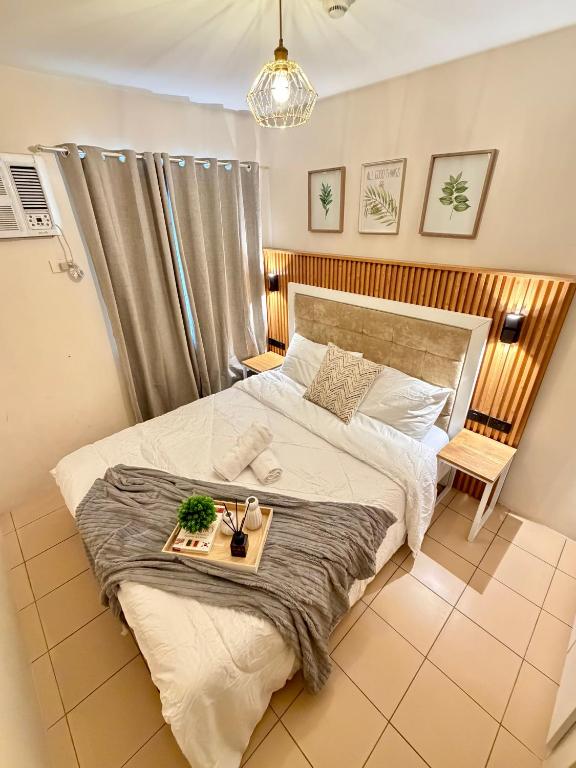 a bedroom with a bed with a tray on it at 8 Spatial Condo in Davao City