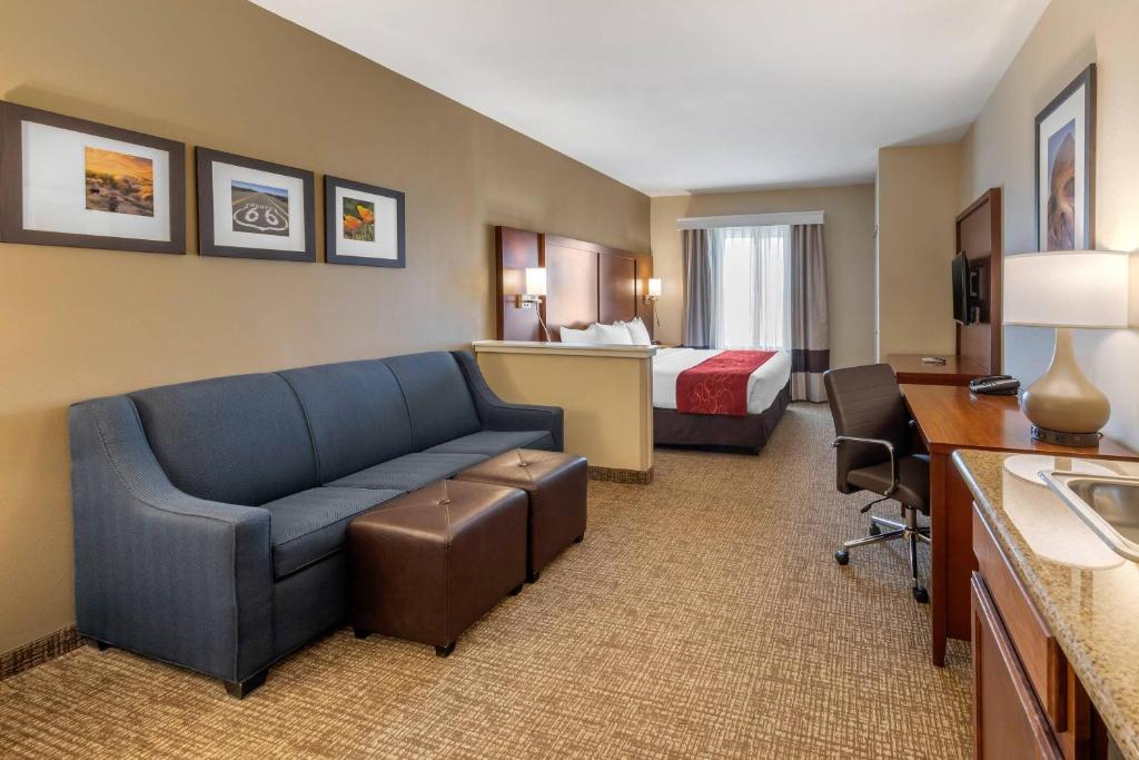 a hotel room with a couch and a bed at Comfort Suites Barstow near I-15 in Barstow