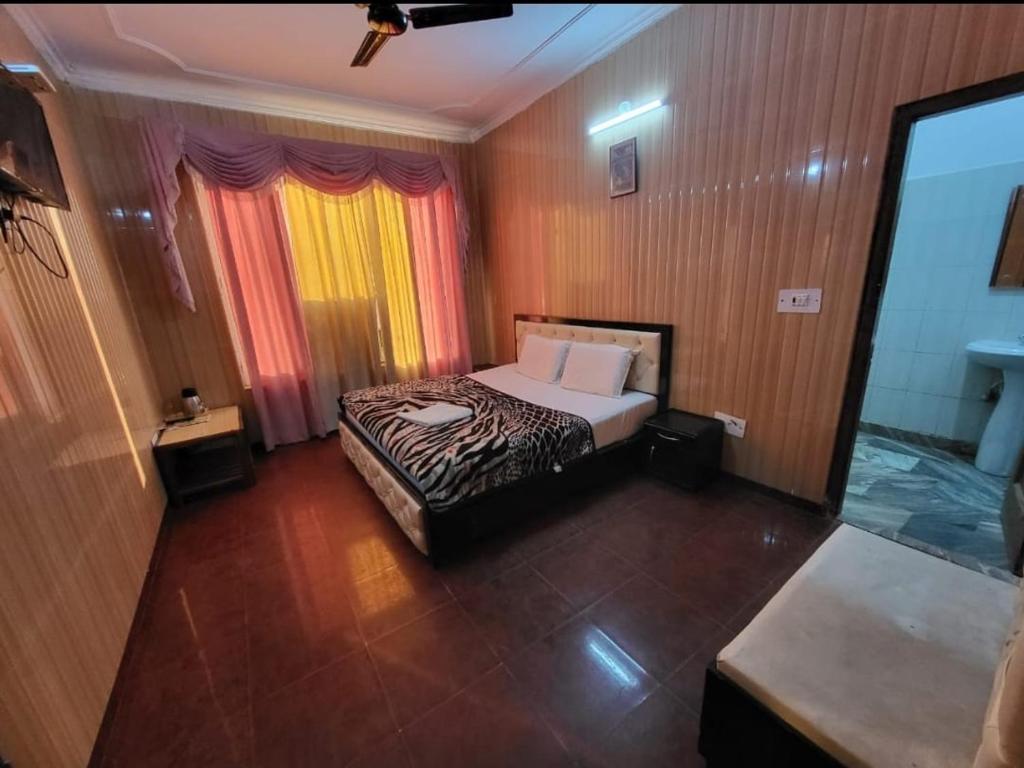 a bedroom with a bed in a room at Pratap Resort in Katra