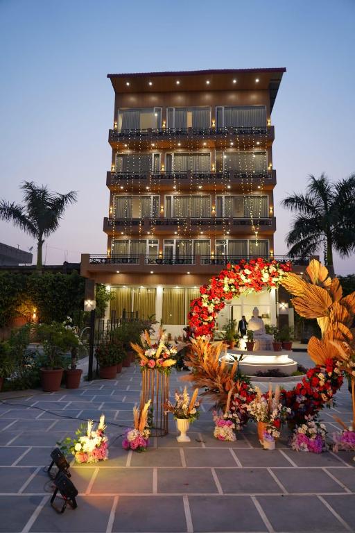 a building with an arch and flowers in front of it at Paradise Resort Paonta in Pāonta Sāhib