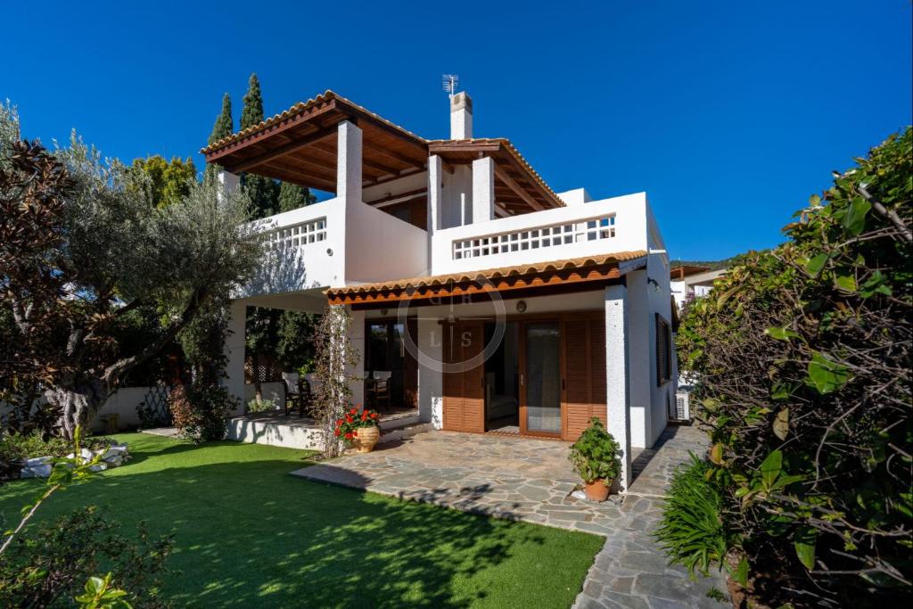 a villa with a view of a yard at Villa Rania - Porto Hydra in Ermioni
