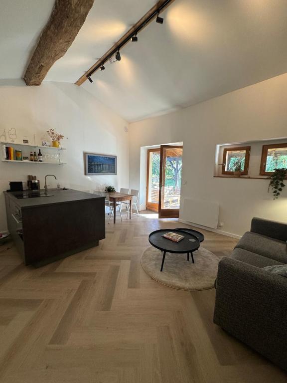 a living room with a couch and a table at Logis Fontaines in Champagnat