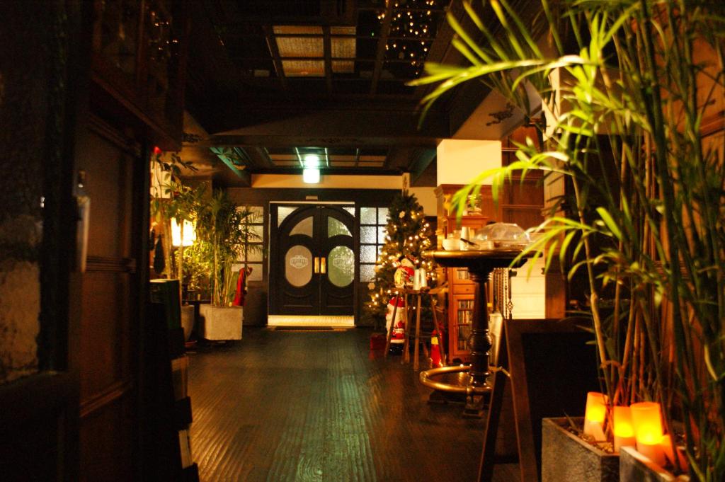 a hallway of a store with a door and plants at Christie Hotel 크리스티 호텔 in Seoul