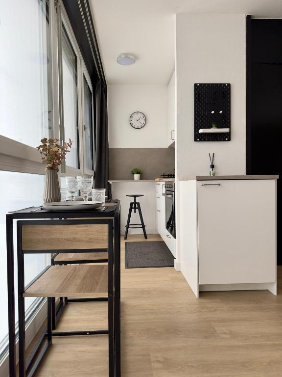 a kitchen with a table and a white kitchen at Studio le Capricorne 22 in Martigny-Ville