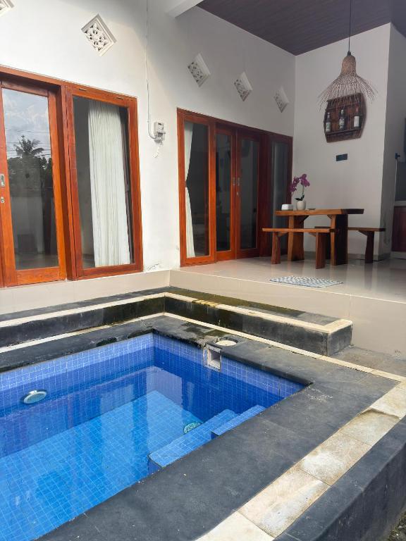 a swimming pool in the middle of a house at Villa Bianca Lovina by GEMA MANAGEMENT BALI in Lovina