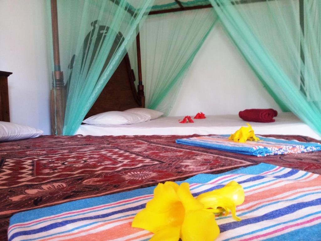 Postel nebo postele na pokoji v ubytování Rainbow Guest House