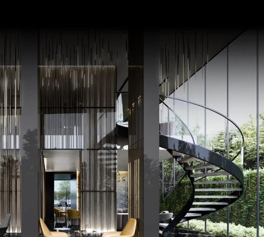 a spiral staircase in a house with a view at Muay Thai Apartment - Ratchada in Bangkok
