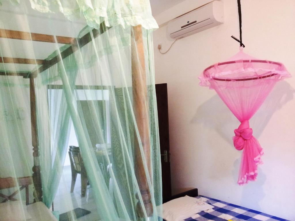 Postel nebo postele na pokoji v ubytování Rainbow Guest House