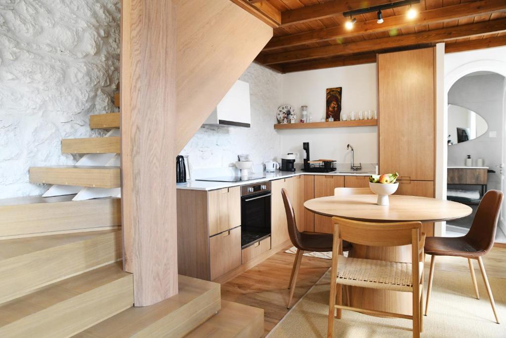 a kitchen with a wooden table and a table and chairs at Anoi Kalymnos in Khoríon