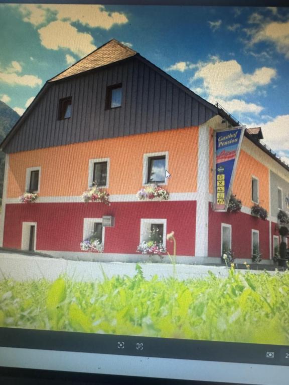 a picture of a building with flowers in the windows at Leitner in Wald am Schoberpaß