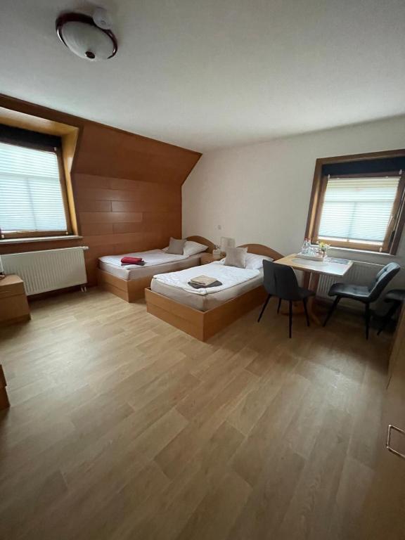 a large room with two beds and a table at Sandstein- & Maerchenhoehle Walldorf GbR in Walldorf