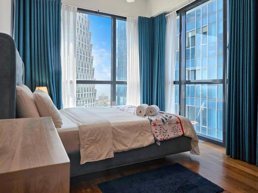 a bedroom with a bed and a large window at Evolve - Céleste in Colombo