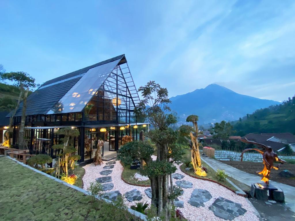a large building with a mountain in the background at Luxcamp Selo - Merapi View by Horison in Selo
