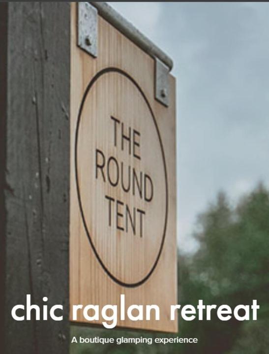a sign that says the roundent on a wooden post at The Round Tent Raglan in Raglan