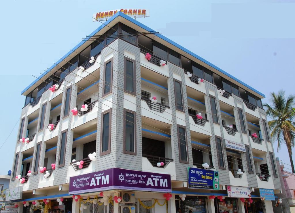a large white building with a lot of windows at Henry Corner in Chikmagalūr