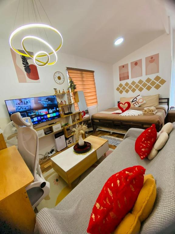 a living room with two couches and a tv at Olango Island - Tiny Guest House - S&E-3 in Lapu Lapu City