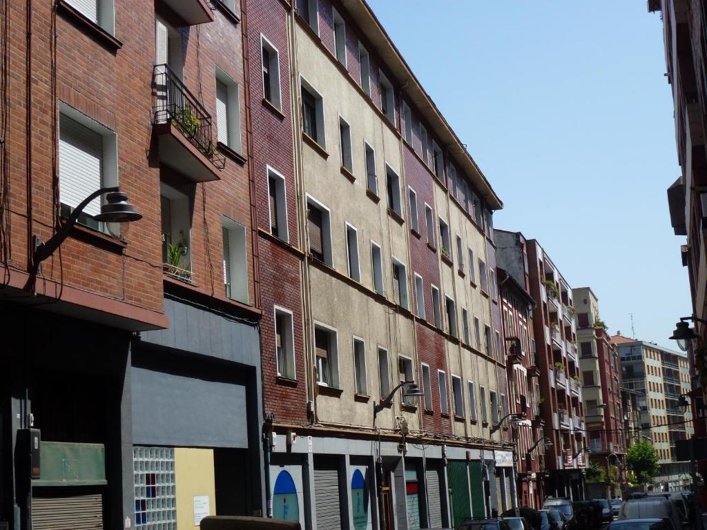 a row of brick buildings on a city street at Casa Narolai in Bilbao