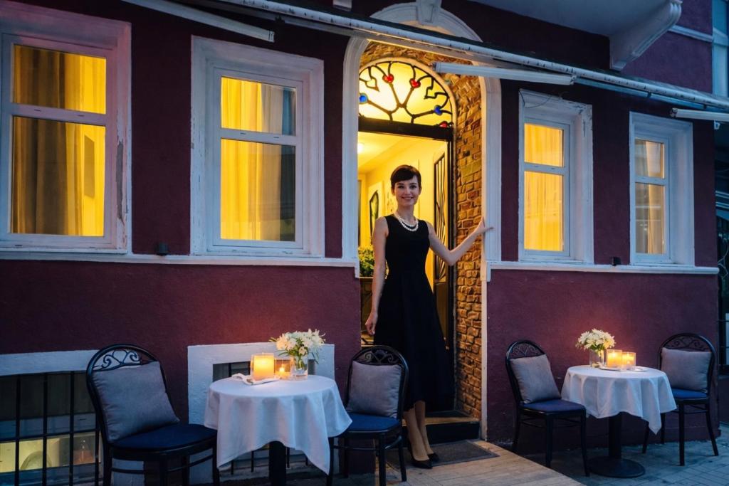 a woman standing in the doorway of a restaurant at The House Company in Istanbul