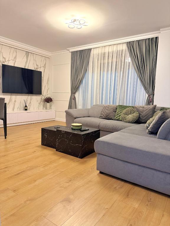 a living room with two couches and a tv at Acasa Concept in Arad
