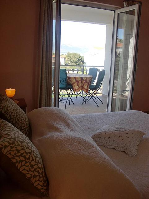 a bedroom with a bed with a view of a patio at Apartment Marina in Slatine
