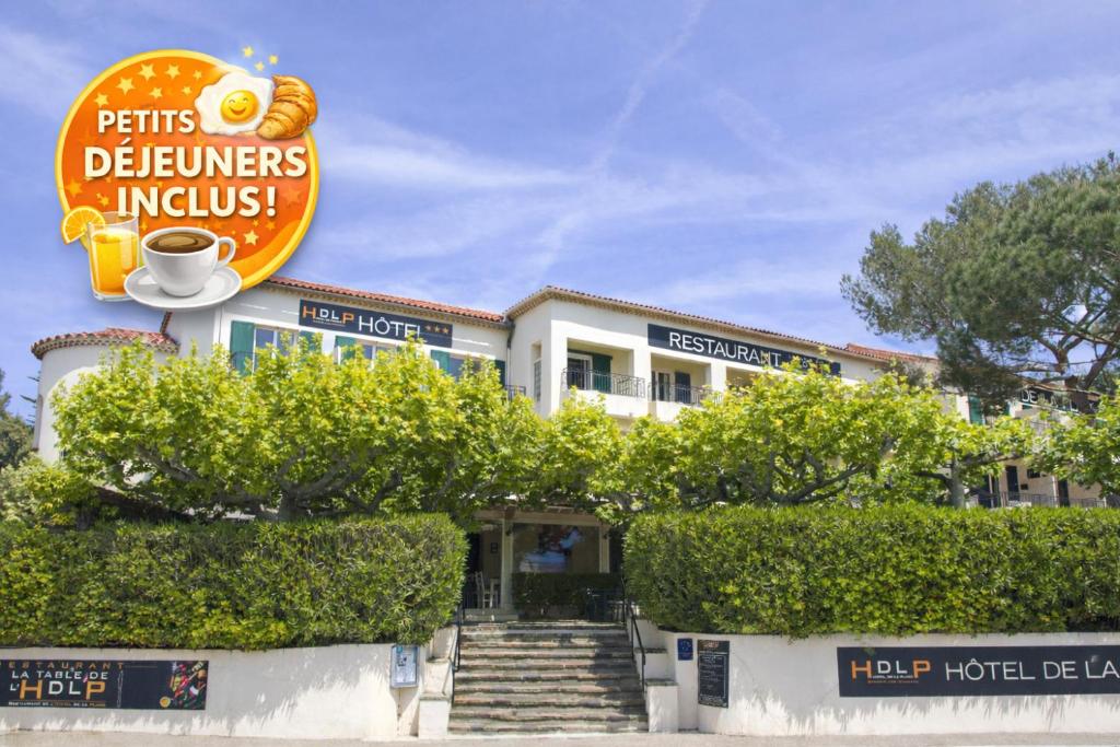 a building with a sign that reads pains deliveries incolis at Hôtel de la Plage - HDLP in Bormes-les-Mimosas