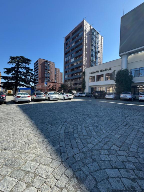 a parking lot with cars parked in front of buildings at Apartment old Batumi in Batumi