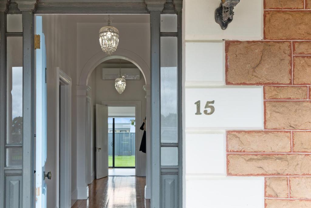 a hallway of a home with a number on the wall at Wallace Cottage in Mount Gambier