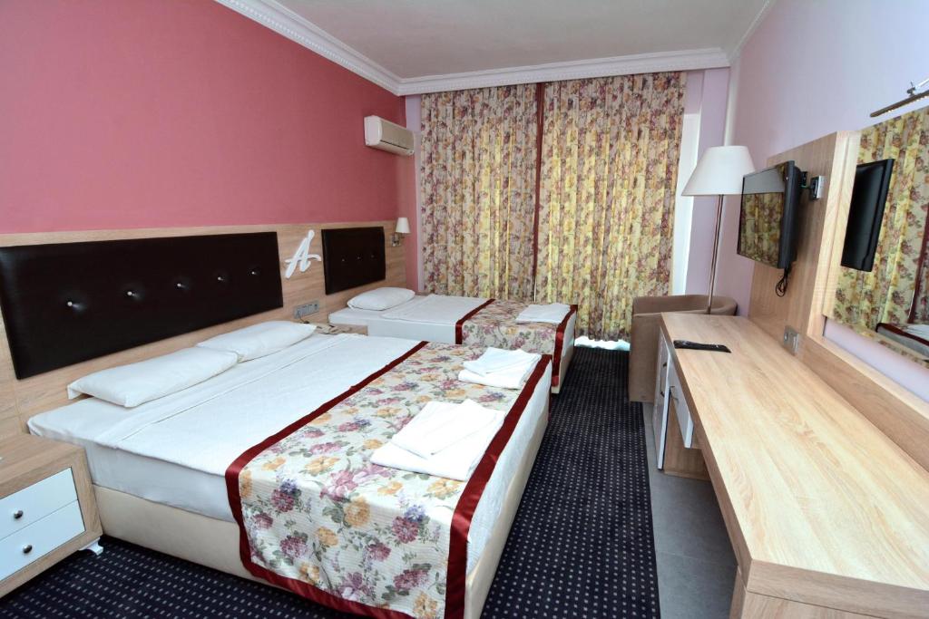 Postel nebo postele na pokoji v ubytování Ananas Hotel