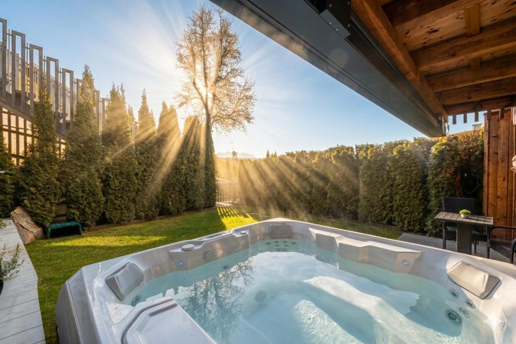 a hot tub in the backyard of a house at Sirona Stay - Private Spa Retreat near Bolzano Dolomites - Romantic Stay with Sauna Whirlpool Garden Garage Free Bolzano Card in San Genesio Atesino