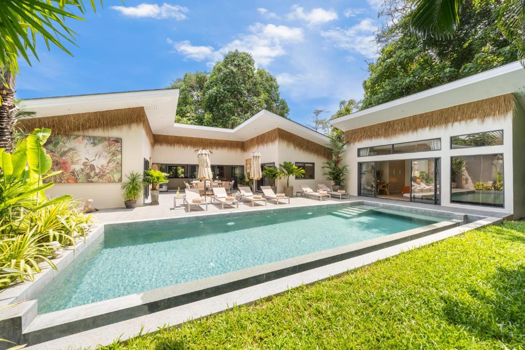 a swimming pool in the backyard of a house at VILLA LOUMA - 4 Bedrooms with Private Pool in Koh Samui