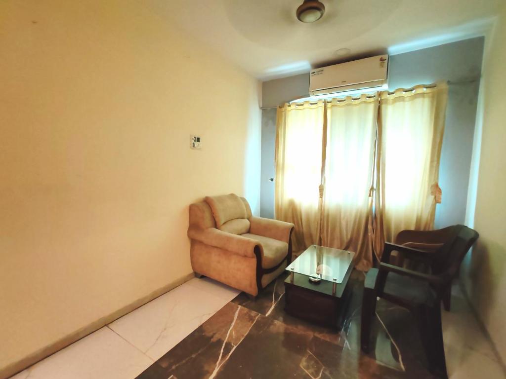 a living room with a chair and a table at Hotel The Star in Kālundri
