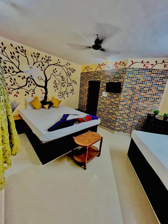 a bedroom with a bed and a bathroom at Sun India Guest House in Howrah